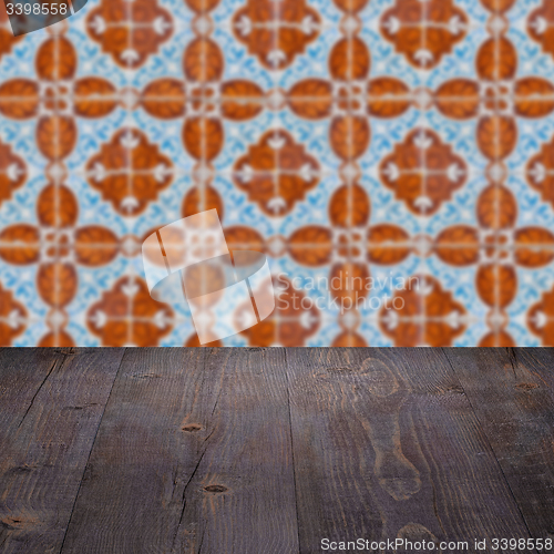 Image of Wood table top and blur vintage ceramic tile pattern wall