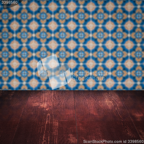 Image of Wood table top and blur vintage ceramic tile pattern wall