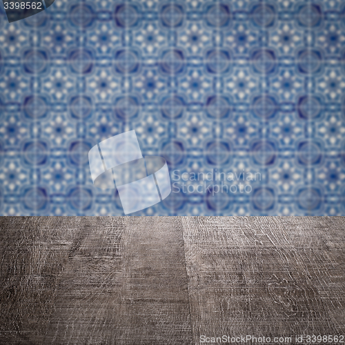 Image of Wood table top and blur vintage ceramic tile pattern wall