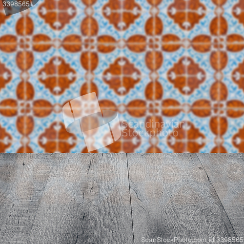 Image of Wood table top and blur vintage ceramic tile pattern wall