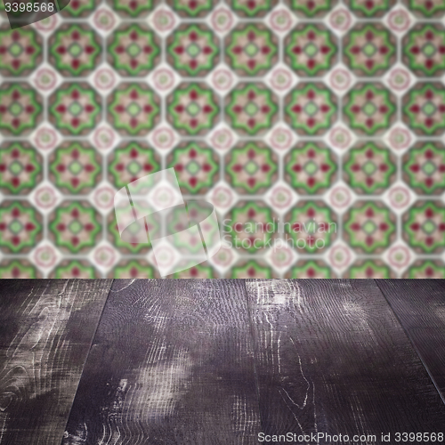 Image of Wood table top and blur vintage ceramic tile pattern wall