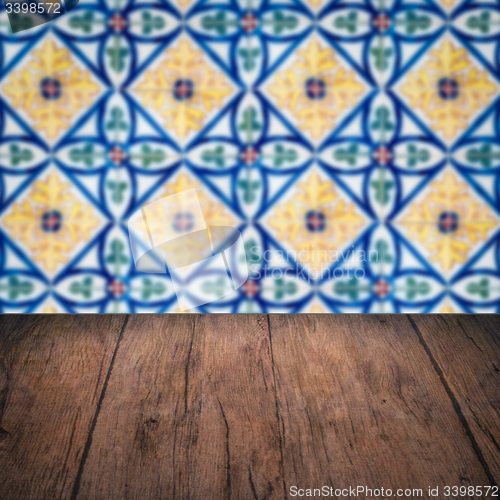 Image of Wood table top and blur vintage ceramic tile pattern wall