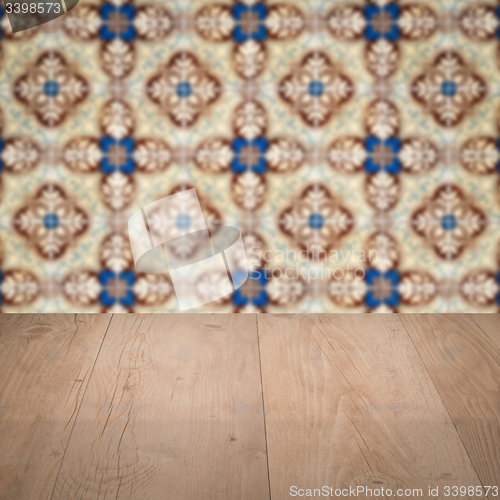 Image of Wood table top and blur vintage ceramic tile pattern wall