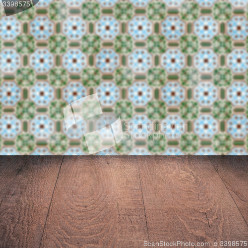 Image of Wood table top and blur vintage ceramic tile pattern wall