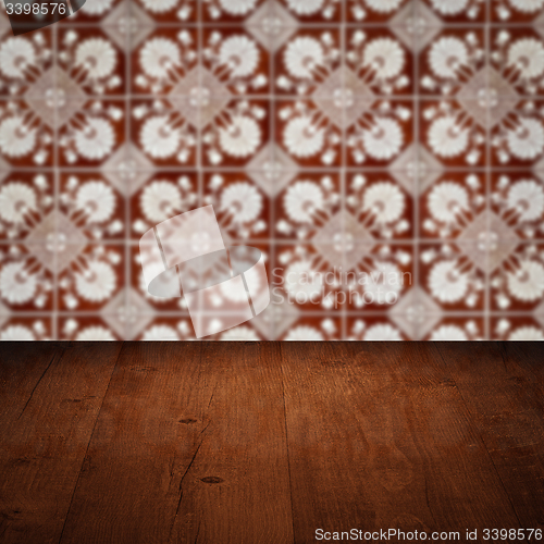 Image of Wood table top and blur vintage ceramic tile pattern wall