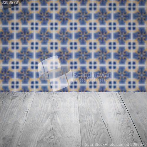 Image of Wood table top and blur vintage ceramic tile pattern wall