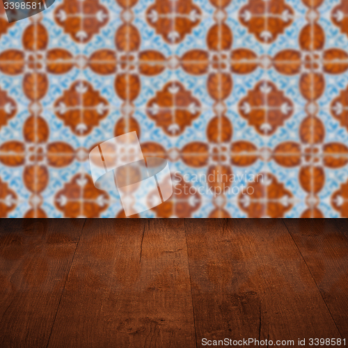 Image of Wood table top and blur vintage ceramic tile pattern wall