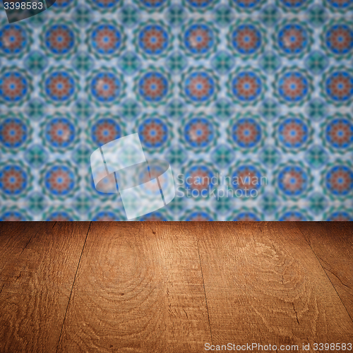 Image of Wood table top and blur vintage ceramic tile pattern wall