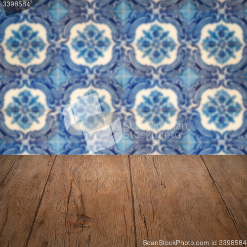 Image of Wood table top and blur vintage ceramic tile pattern wall