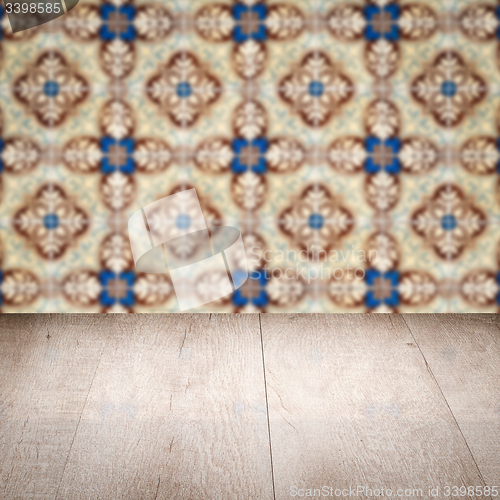 Image of Wood table top and blur vintage ceramic tile pattern wall