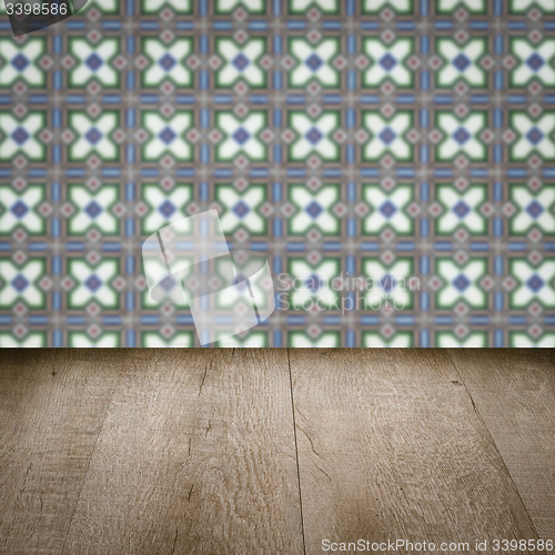 Image of Wood table top and blur vintage ceramic tile pattern wall