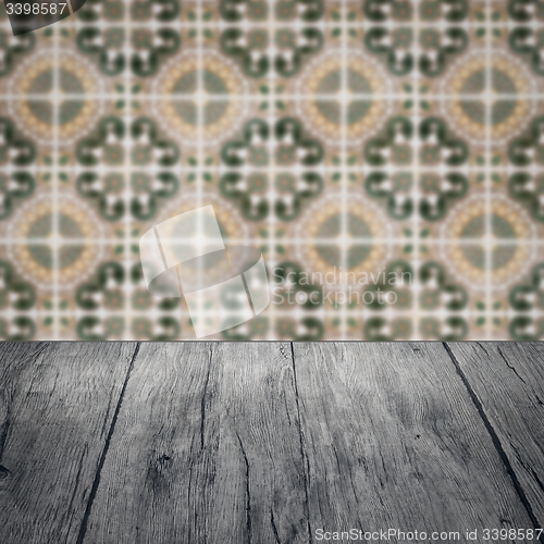 Image of Wood table top and blur vintage ceramic tile pattern wall