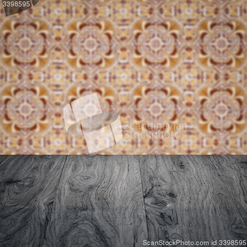 Image of Wood table top and blur vintage ceramic tile pattern wall