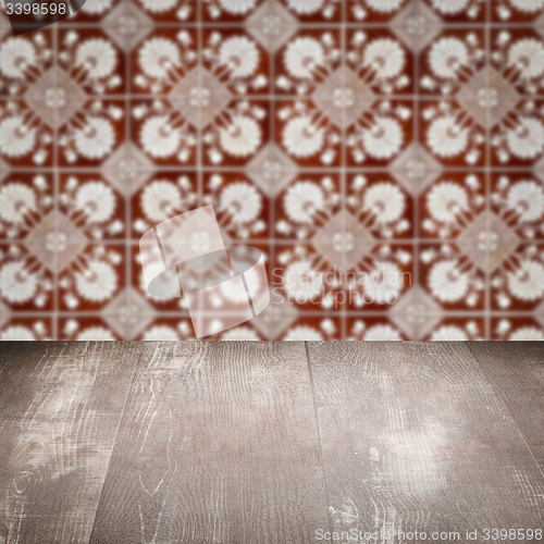 Image of Wood table top and blur vintage ceramic tile pattern wall