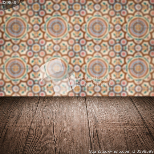 Image of Wood table top and blur vintage ceramic tile pattern wall