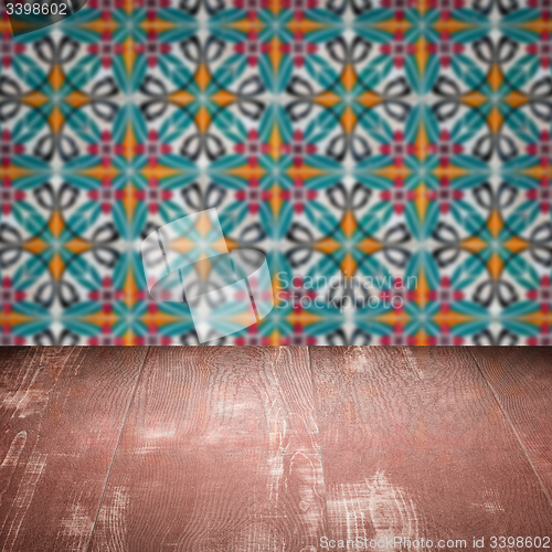 Image of Wood table top and blur vintage ceramic tile pattern wall