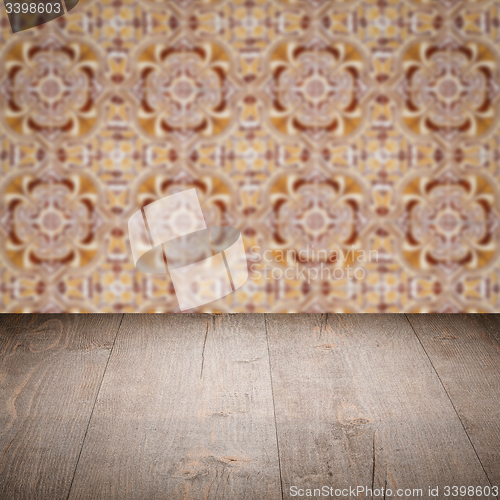Image of Wood table top and blur vintage ceramic tile pattern wall