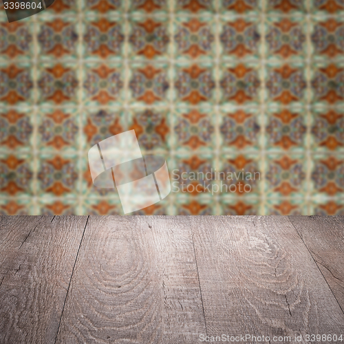 Image of Wood table top and blur vintage ceramic tile pattern wall