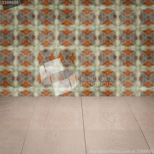 Image of Wood table top and blur vintage ceramic tile pattern wall