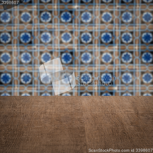 Image of Wood table top and blur vintage ceramic tile pattern wall