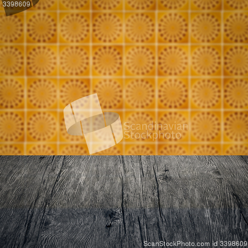 Image of Wood table top and blur vintage ceramic tile pattern wall
