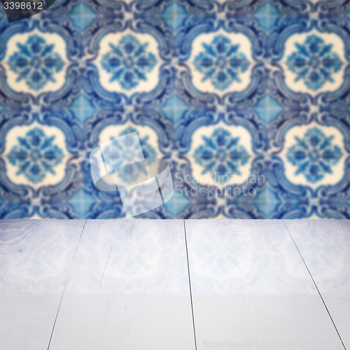 Image of Wood table top and blur vintage ceramic tile pattern wall