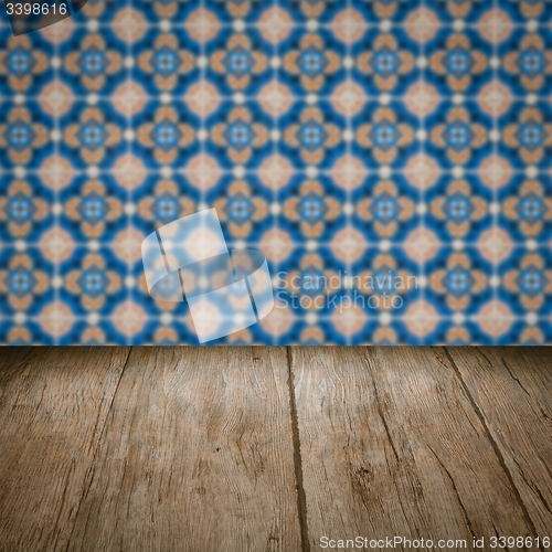 Image of Wood table top and blur vintage ceramic tile pattern wall