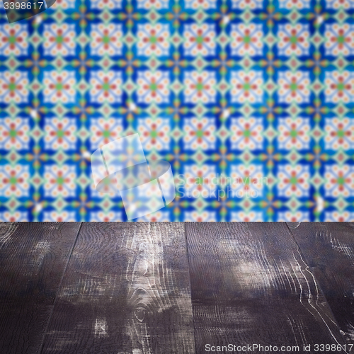 Image of Wood table top and blur vintage ceramic tile pattern wall