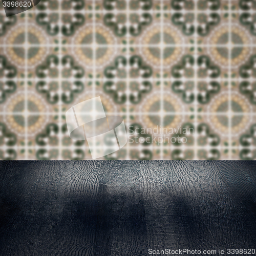 Image of Wood table top and blur vintage ceramic tile pattern wall