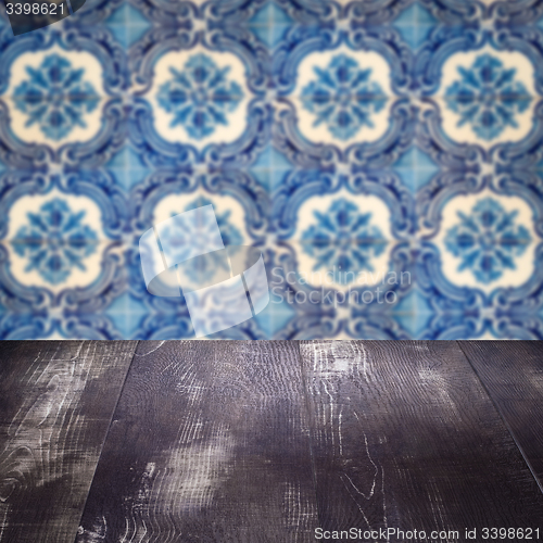 Image of Wood table top and blur vintage ceramic tile pattern wall