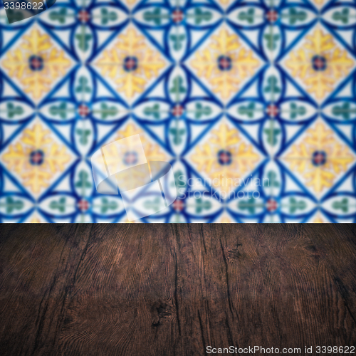 Image of Wood table top and blur vintage ceramic tile pattern wall