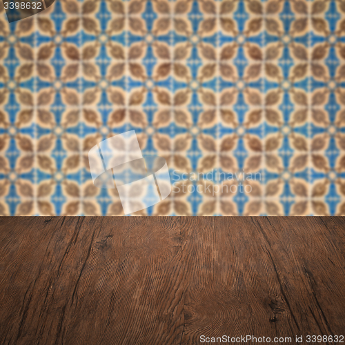 Image of Wood table top and blur vintage ceramic tile pattern wall