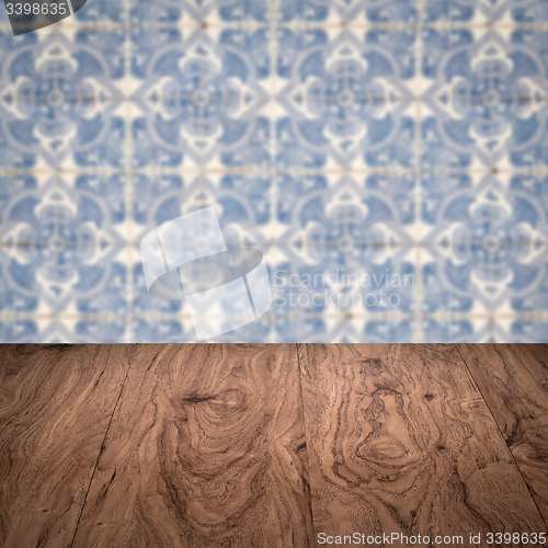 Image of Wood table top and blur vintage ceramic tile pattern wall