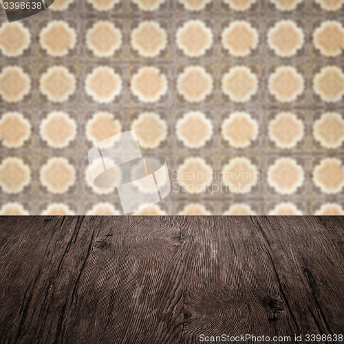Image of Wood table top and blur vintage ceramic tile pattern wall