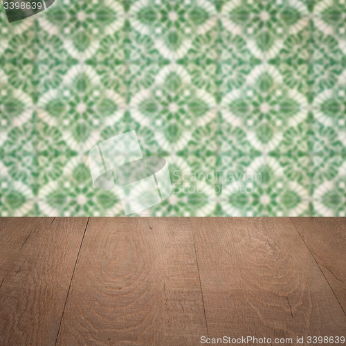 Image of Wood table top and blur vintage ceramic tile pattern wall