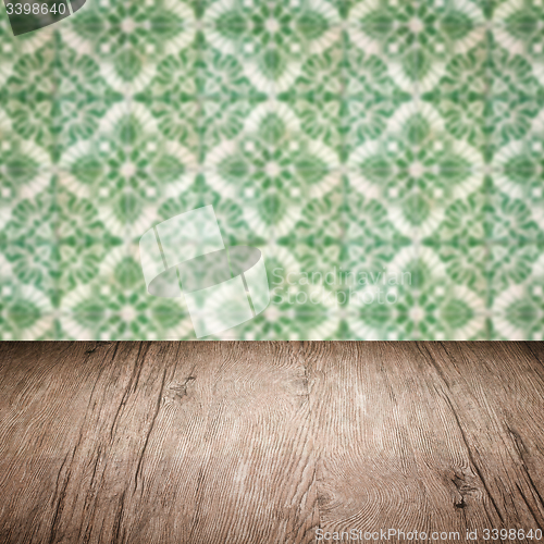Image of Wood table top and blur vintage ceramic tile pattern wall