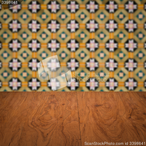 Image of Wood table top and blur vintage ceramic tile pattern wall