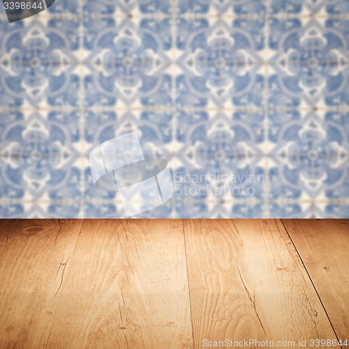 Image of Wood table top and blur vintage ceramic tile pattern wall