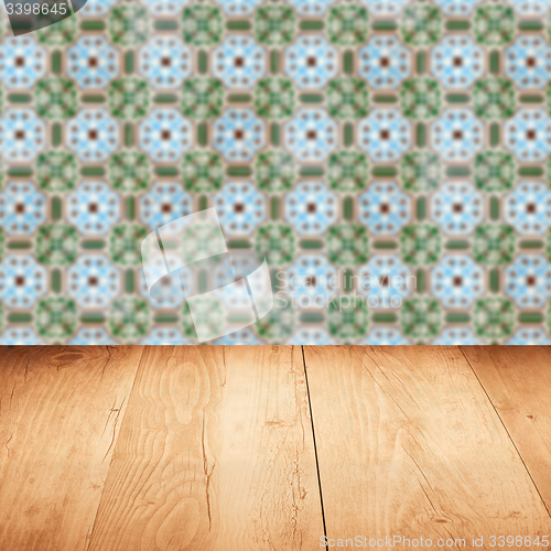 Image of Wood table top and blur vintage ceramic tile pattern wall