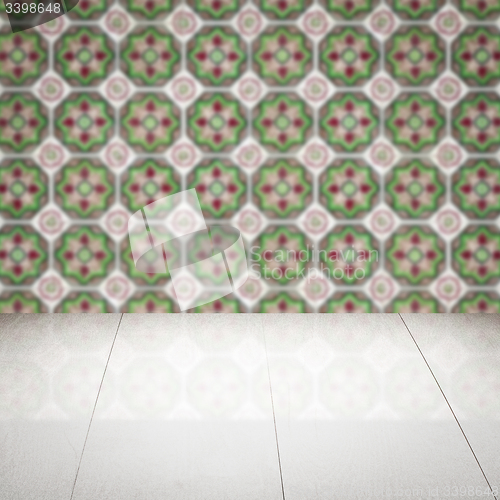 Image of Wood table top and blur vintage ceramic tile pattern wall