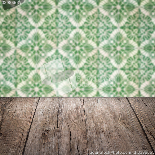 Image of Wood table top and blur vintage ceramic tile pattern wall