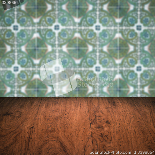 Image of Wood table top and blur vintage ceramic tile pattern wall