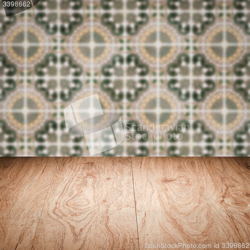 Image of Wood table top and blur vintage ceramic tile pattern wall