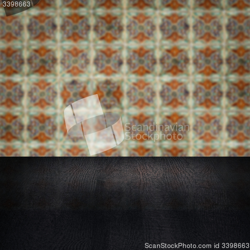 Image of Wood table top and blur vintage ceramic tile pattern wall