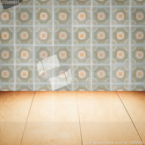 Image of Wood table top and blur vintage ceramic tile pattern wall
