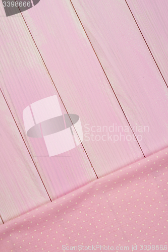 Image of Pink towel over wooden table