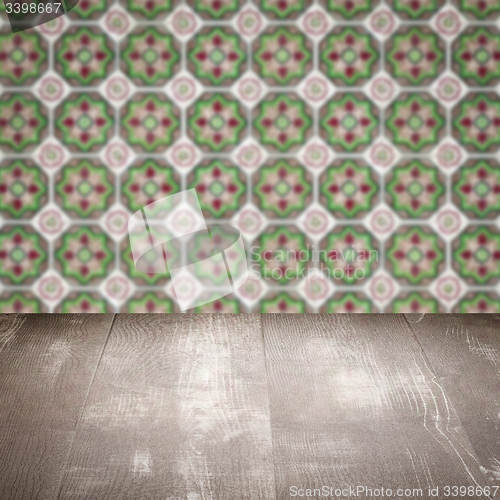 Image of Wood table top and blur vintage ceramic tile pattern wall