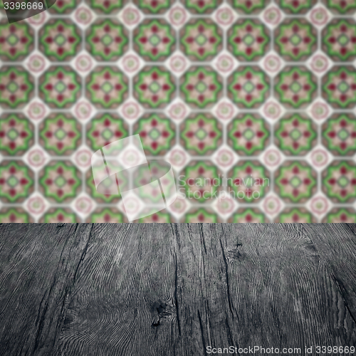 Image of Wood table top and blur vintage ceramic tile pattern wall