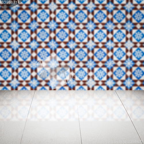 Image of Wood table top and blur vintage ceramic tile pattern wall