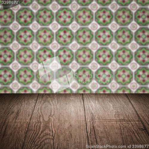 Image of Wood table top and blur vintage ceramic tile pattern wall